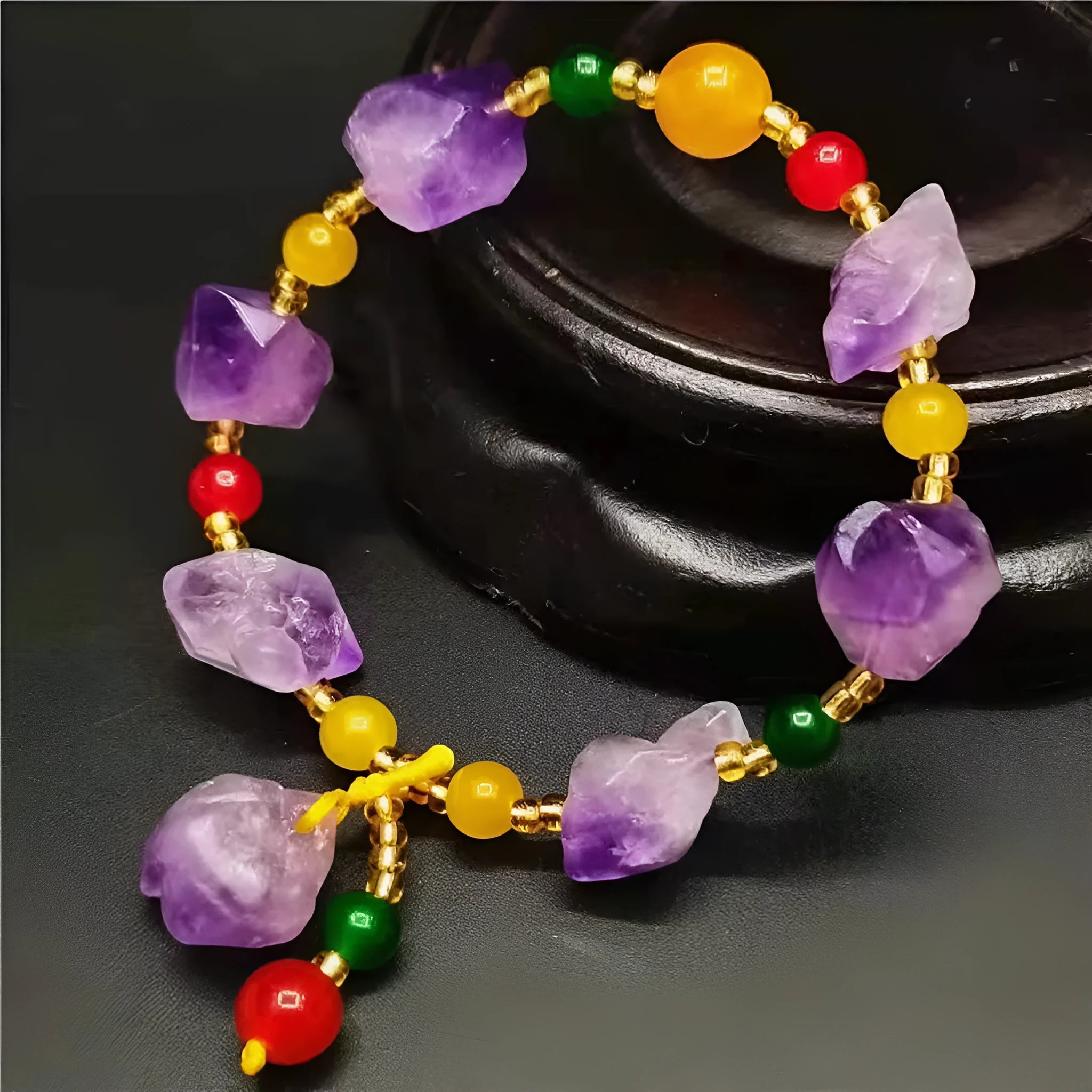 A women's bracelet made of purple natural amethyst beads with a fu character charm.