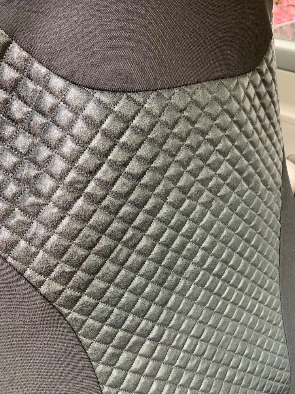 Black quilted automotive seat cover with plastic hooks for car interior protection