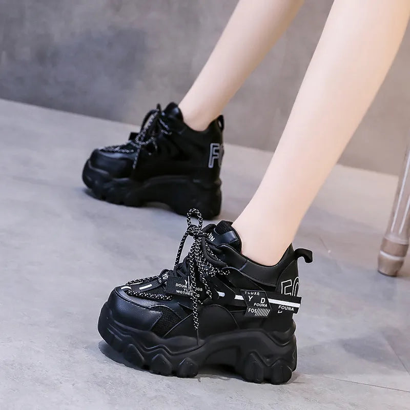 Women's white mesh platform sports shoes with cross strap and a high rubber sole.