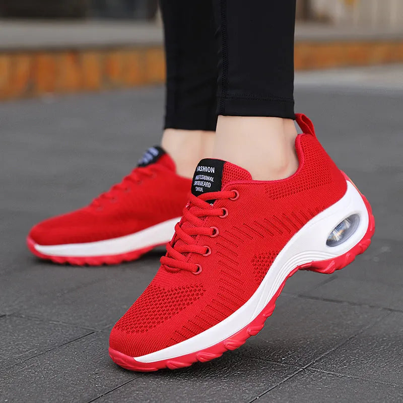 Red and black women's low top lace-up mesh sneakers with a round toe and flat PU sole.