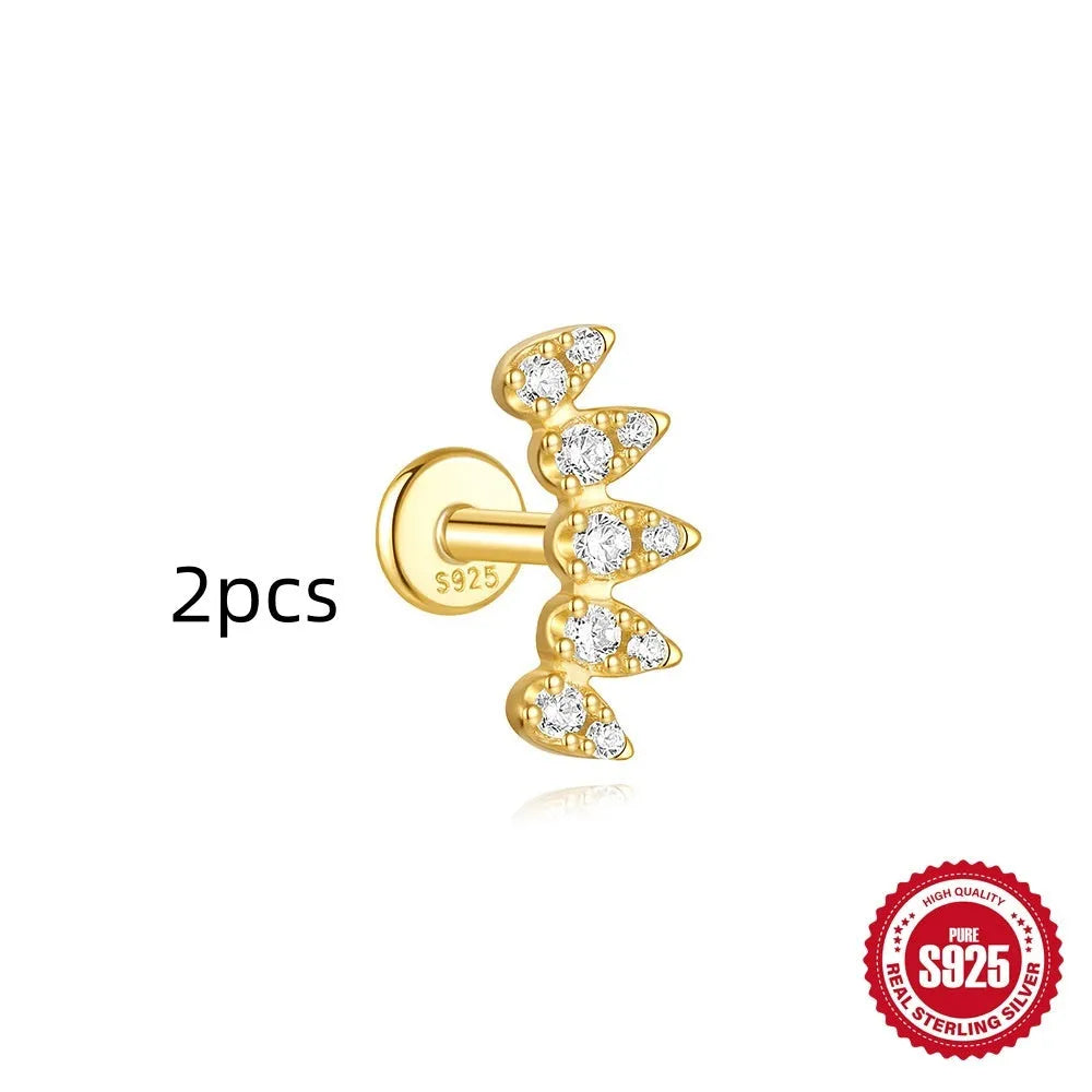 Geometric kite-shaped sterling silver stud earrings with rhinestones and a gold chain tassel.