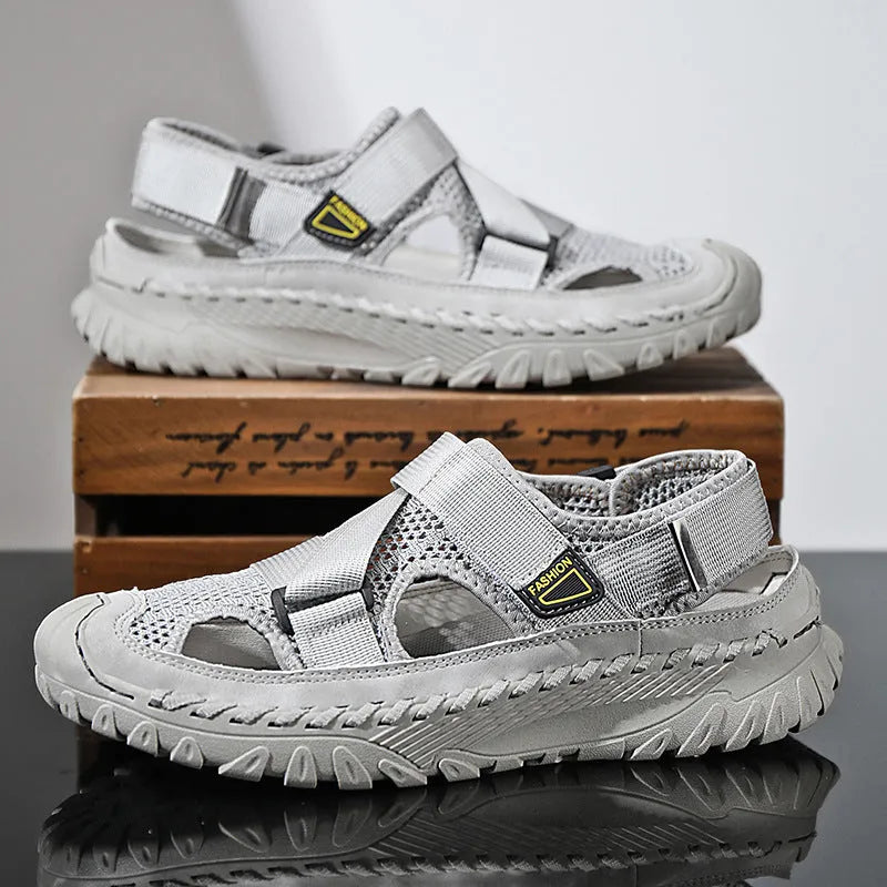 Men's grey genuine leather sandals with mesh lining and an elastic band on a rubber sole.