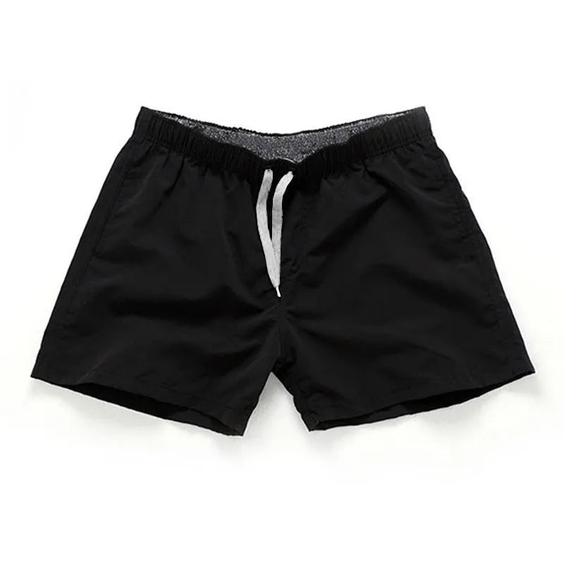 Men's straight-leg beach shorts in polyester fabric on a beach background