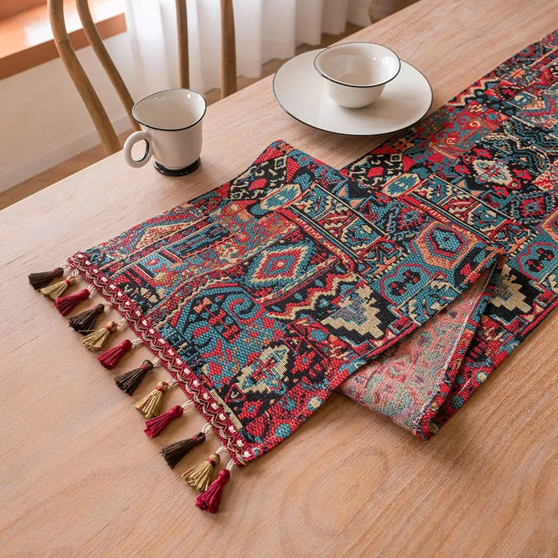 Nordic jacquard table runner with tassel trim in dark blue striped pattern laid on a wooden table.