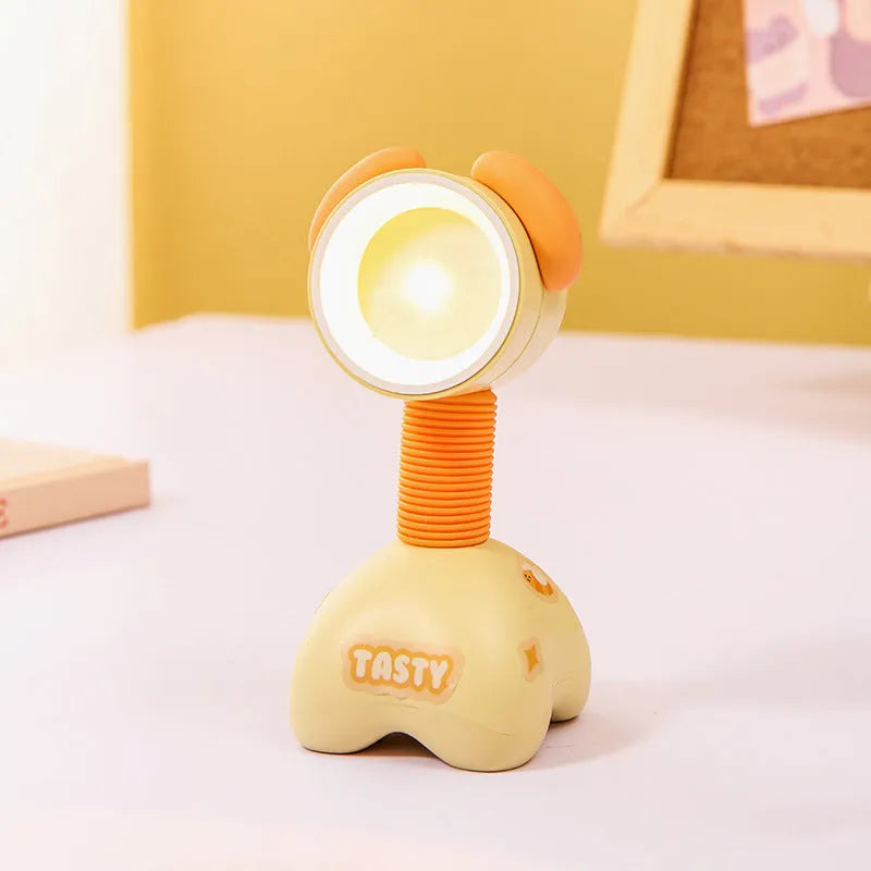 DIY cartoon animal small night lamp with magnetic base in assorted colours on a desk.
