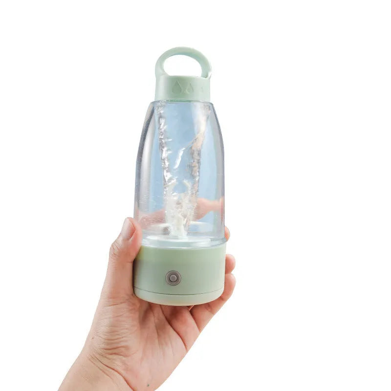 Automatic electric shaker bottle in green with USB charging port and handle.