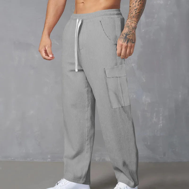 Men's corduroy cargo trousers in loose fit wide-leg design with elastic waist