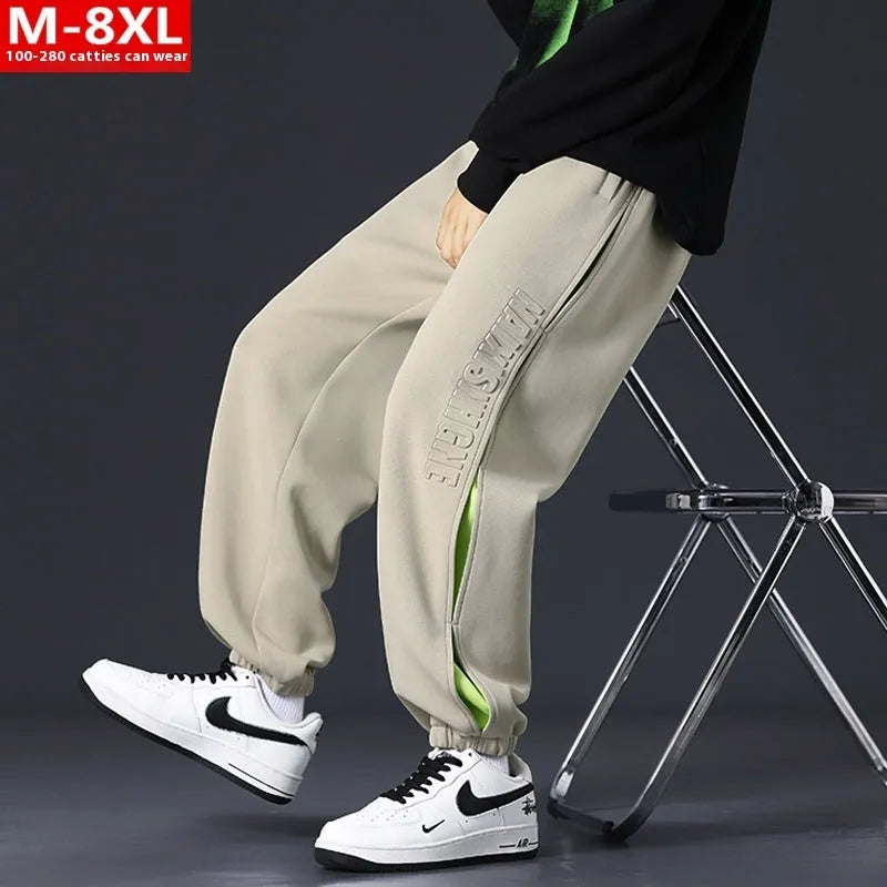 Men's loose fit cotton casual trousers with stitching print design and banded ankle cuffs.