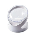 Clear plastic elevated cat food bowl with tilt design on white surface