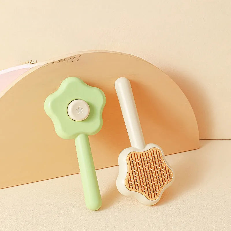 Green self-cleaning cat comb with stainless steel needles and retraction button