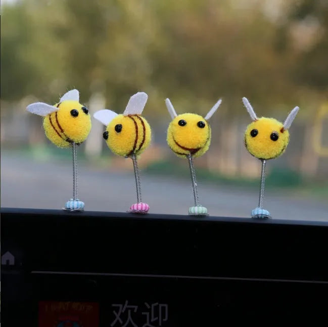 Yellow and black cartoon bee car decoration made from fur ball material measuring 3x3cm
