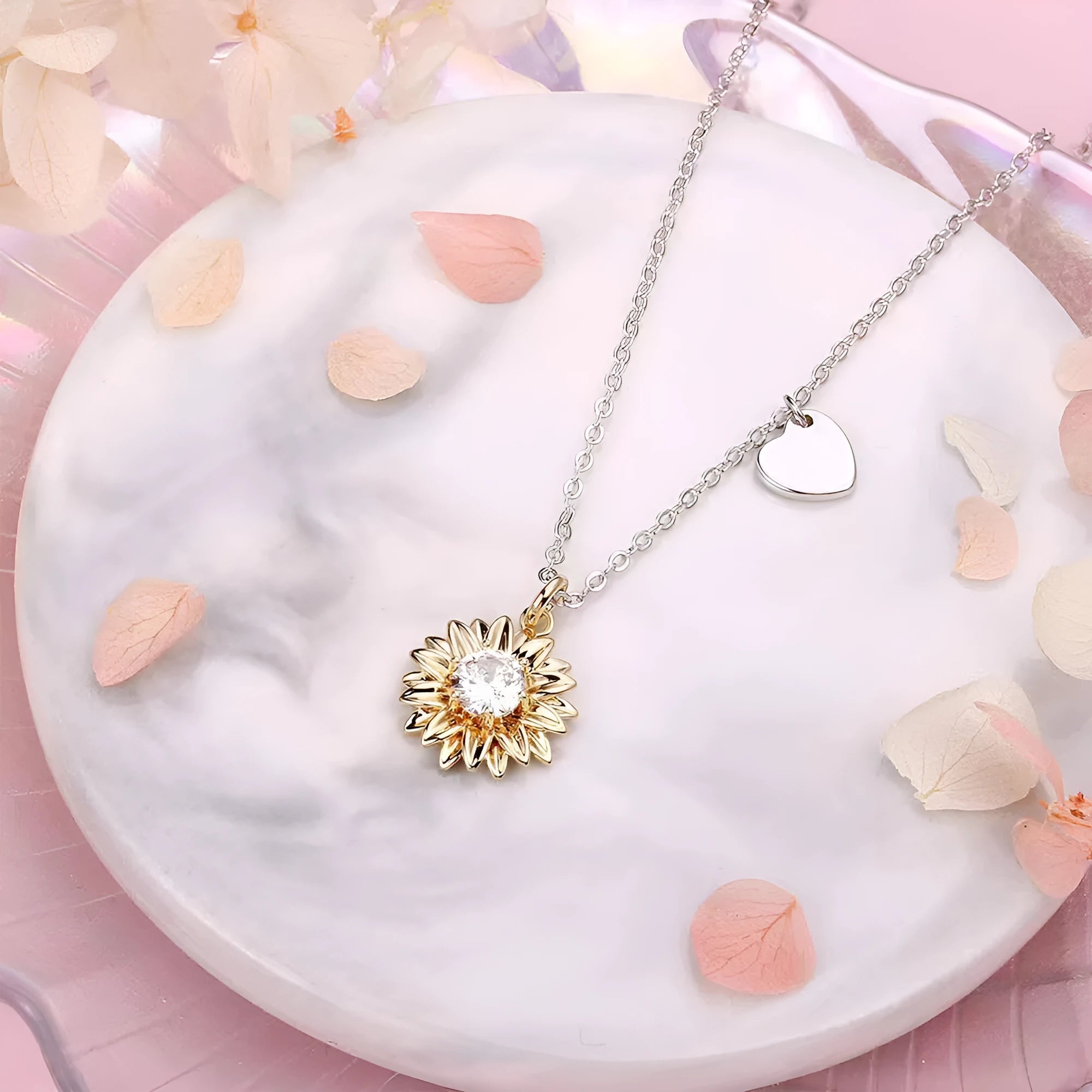 Close-up of a women's 925 silver necklace with a small daisy petal pendant on a cross chain, laid flat to show length.