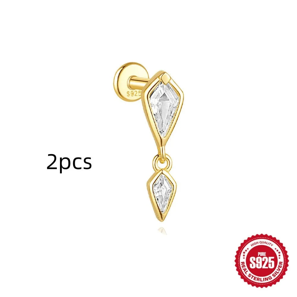 Geometric kite-shaped sterling silver stud earrings with rhinestones and a gold chain tassel.
