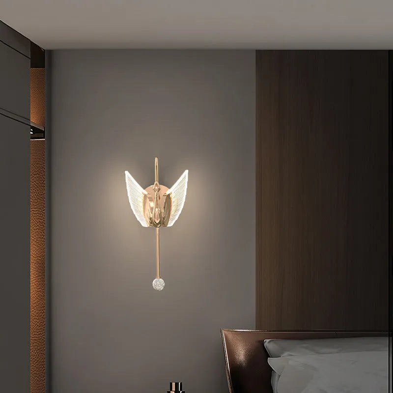 Gold swan-shaped wall lamp with acrylic shade and dimmable LED light.