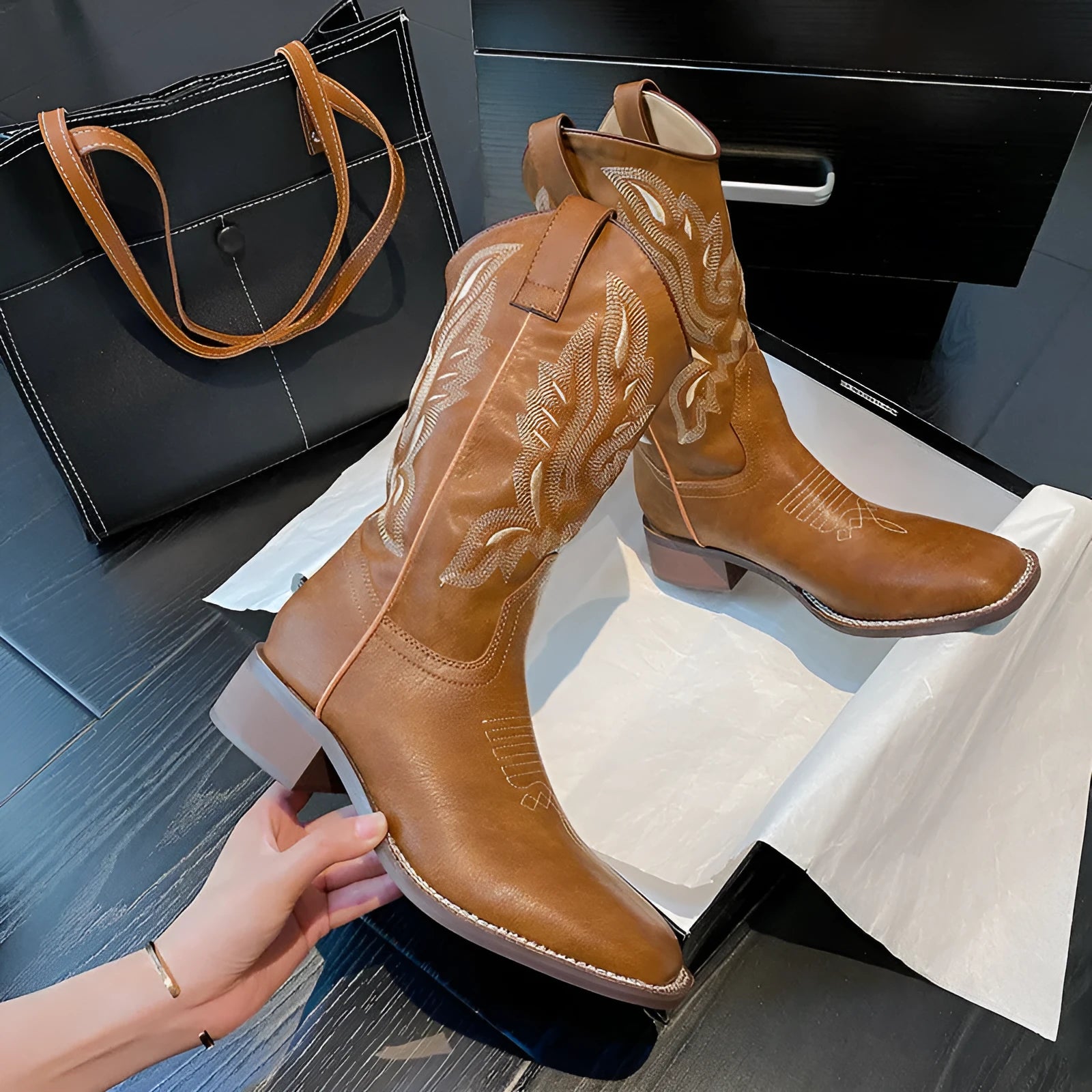 Brown women's Martin boots with embroidered pattern and mid-calf length, showing low square heel and round toe