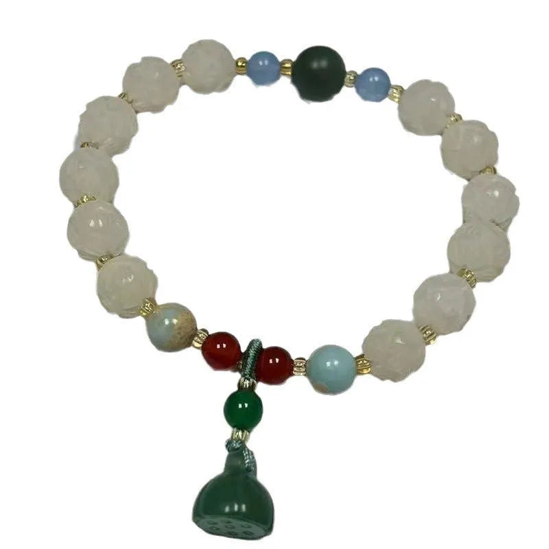 Carved Bodhi root bracelet with white jade, lotus, and pumpkin beads in various sizes.