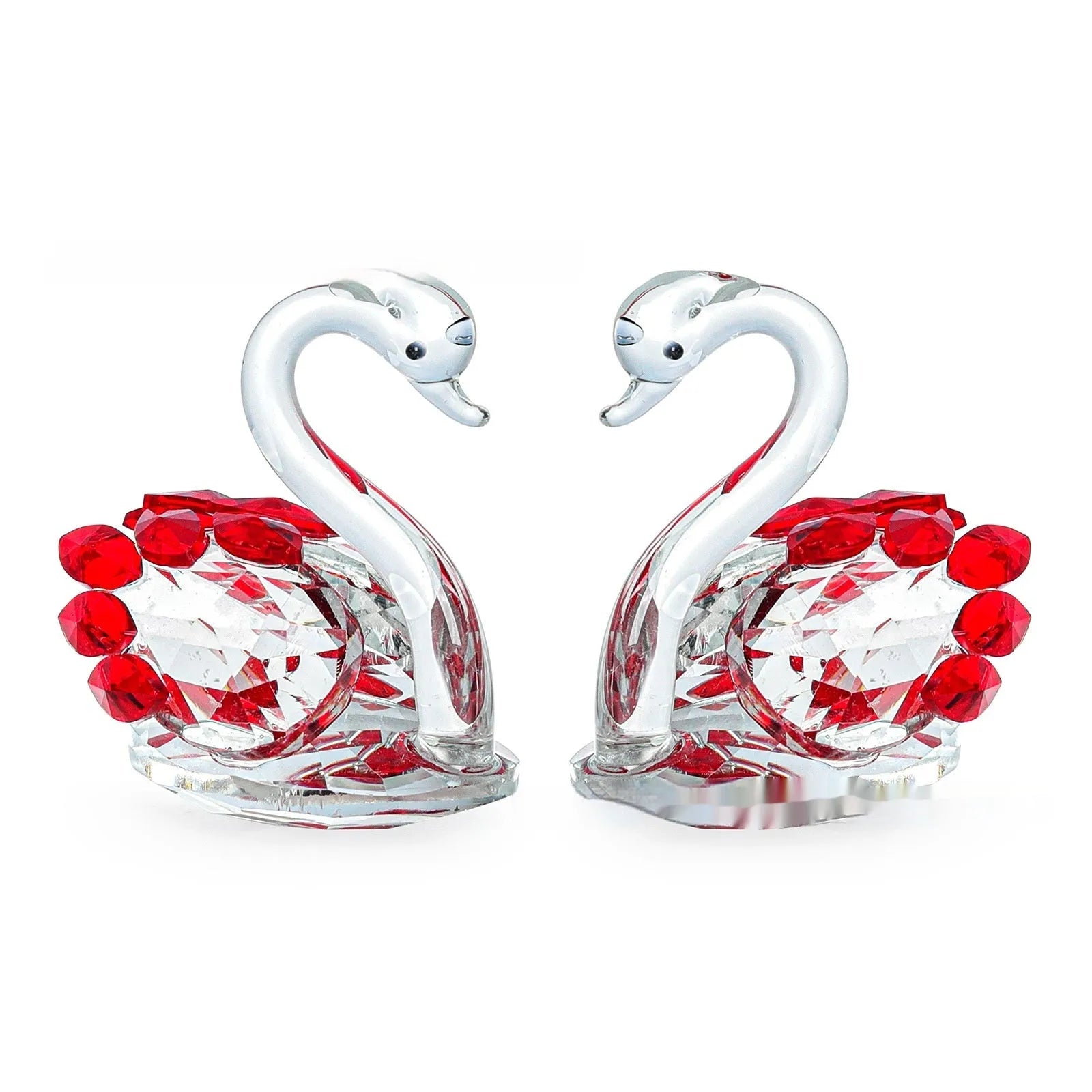 White crystal swan decoration on a desktop in solid head and empty tube styles.