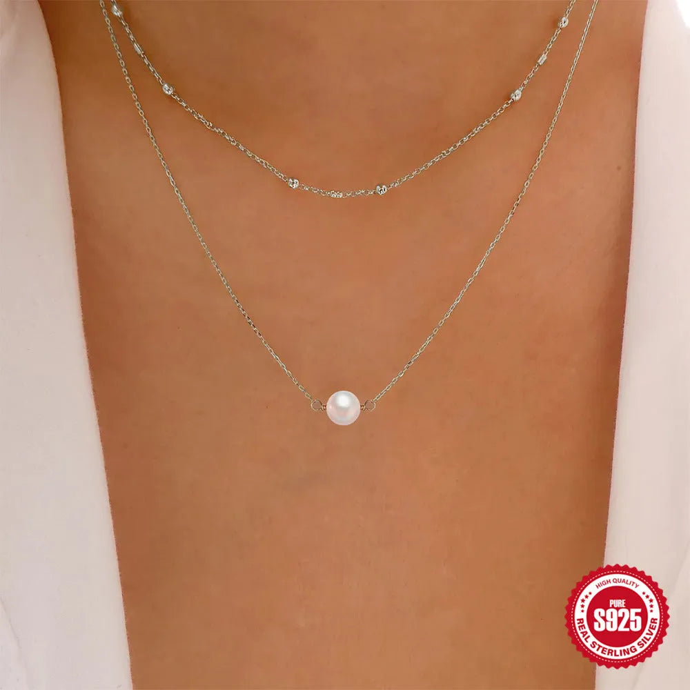 S925 sterling silver double layer necklace with twin geometric pearls in gold or white gold plating.