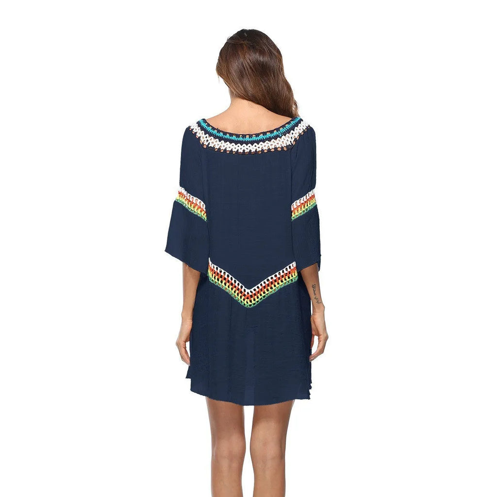Women's crocheted white beach cover-up top for sun protection during swimming.