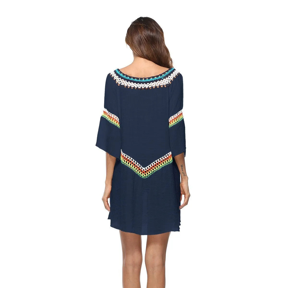 Women's crocheted white beach cover-up top for sun protection during swimming.
