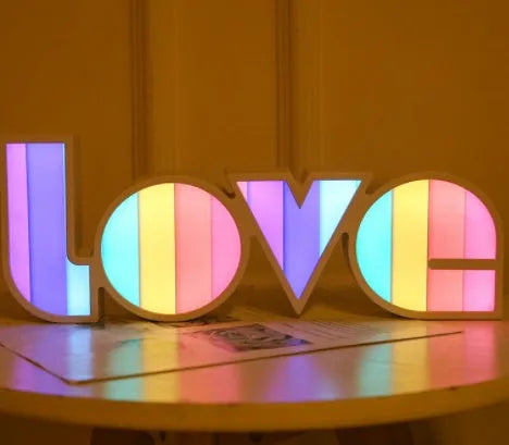 LED decorative light with rainbow-coloured LOVE word on plastic shade