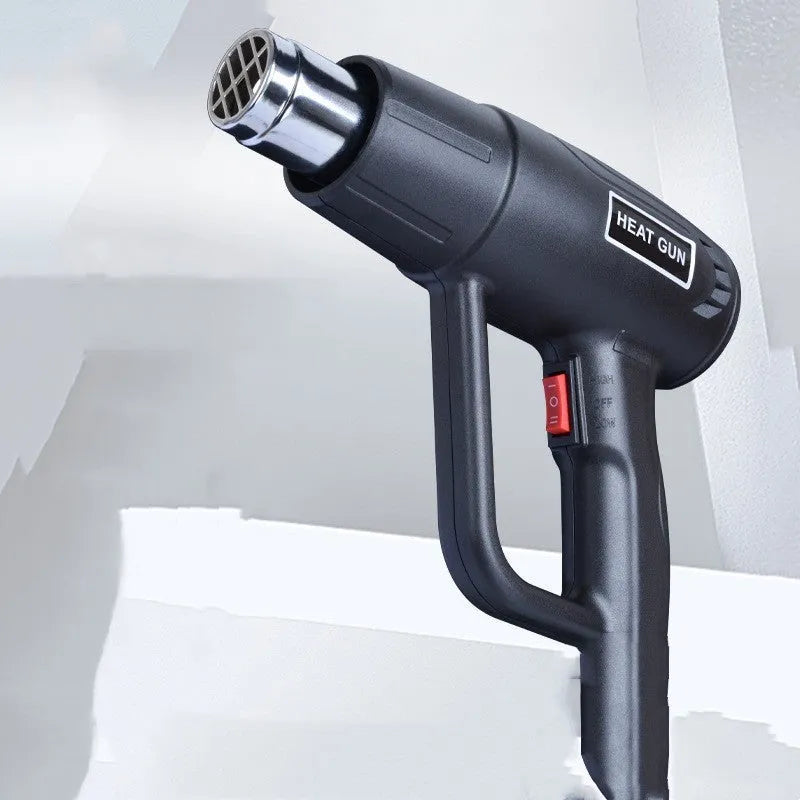 Black industrial 2000W hot air gun with grid air outlet and two-gear switch for temperature control.