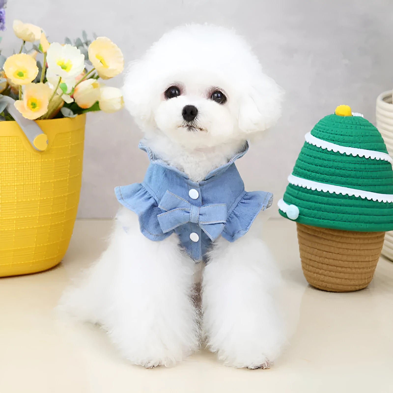 Blue denim dress for a dog or cat with ruffles and a metal leash hook on the chest.