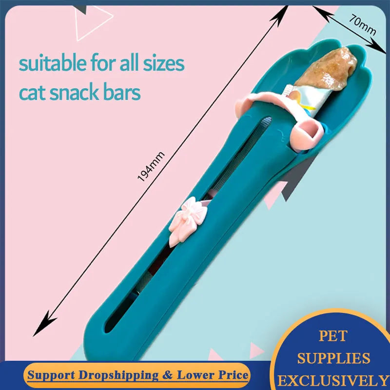 Green and pink pet food squeezer feeder with attached spoon for dispensing liquid and dry food