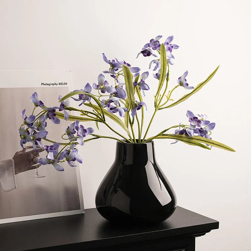 Ceramic decorative vase with artificial flowers in black or white modern design