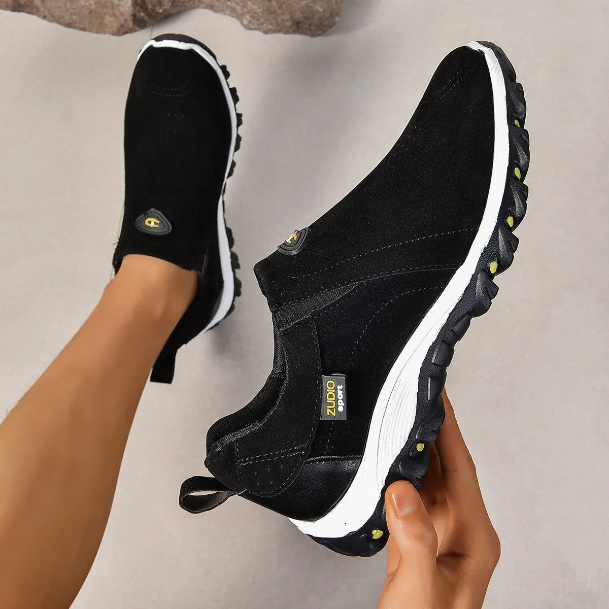 Men's black elastic slip-on shoe covers with round toe and rubber sole, showing PU upper material.