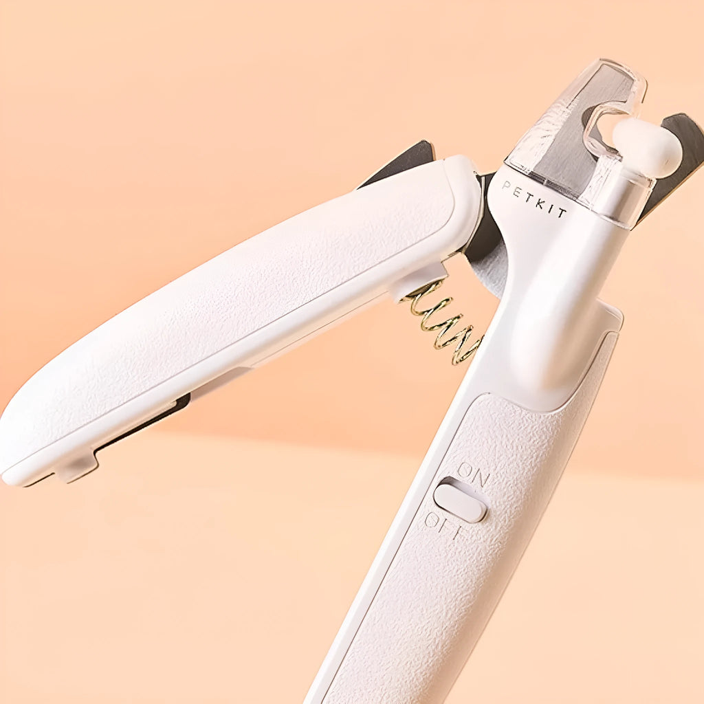 White LED pet nail clipper with a triangular blade, anti-splash guard, and leatherette handle.