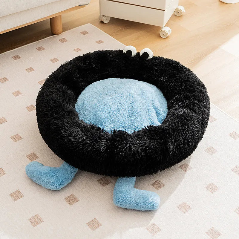 Blue plush kennel sleeping mat for small dog with raised edges, shown on a wooden floor.