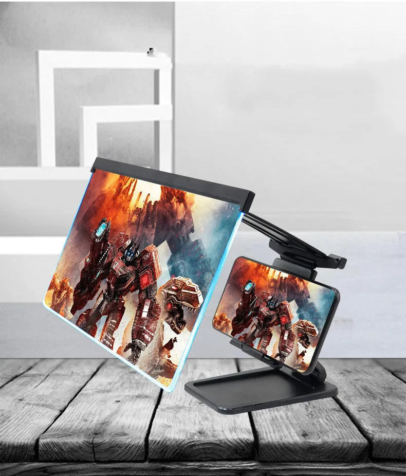 Black folding mobile phone screen magnifier with detachable holder on a desktop.