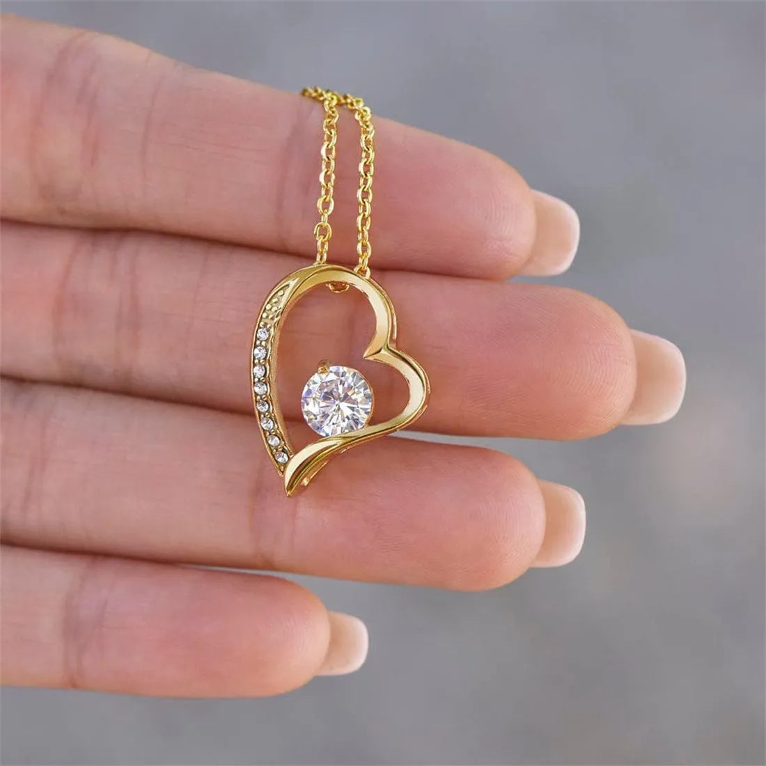 Hollow heart-shaped pendant necklace in gold or silver finish with gift box and card.