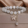 Women's white cat's eye stone bracelet with morganite safety buckle and flower tassel decoration