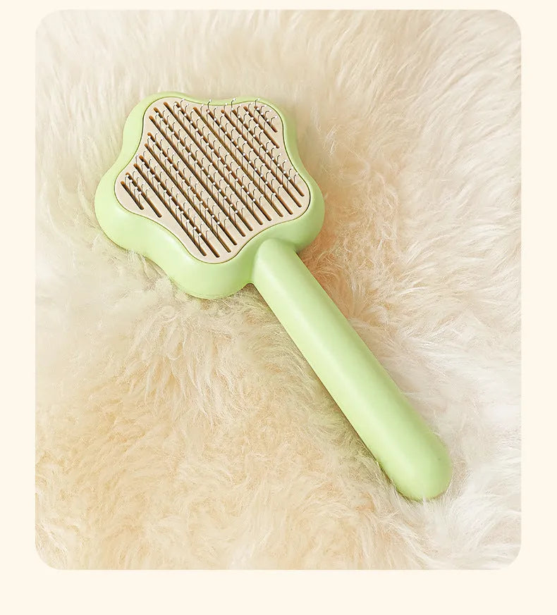 Green self-cleaning cat comb with stainless steel needles and retraction button