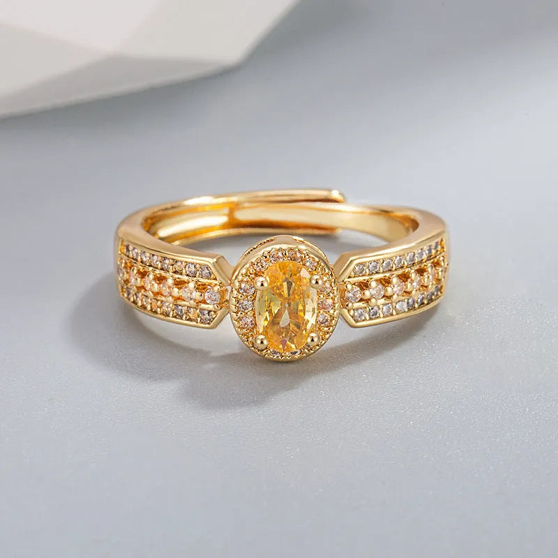 Champagne gold copper ring with open adjustable design and diamond setting against a white background