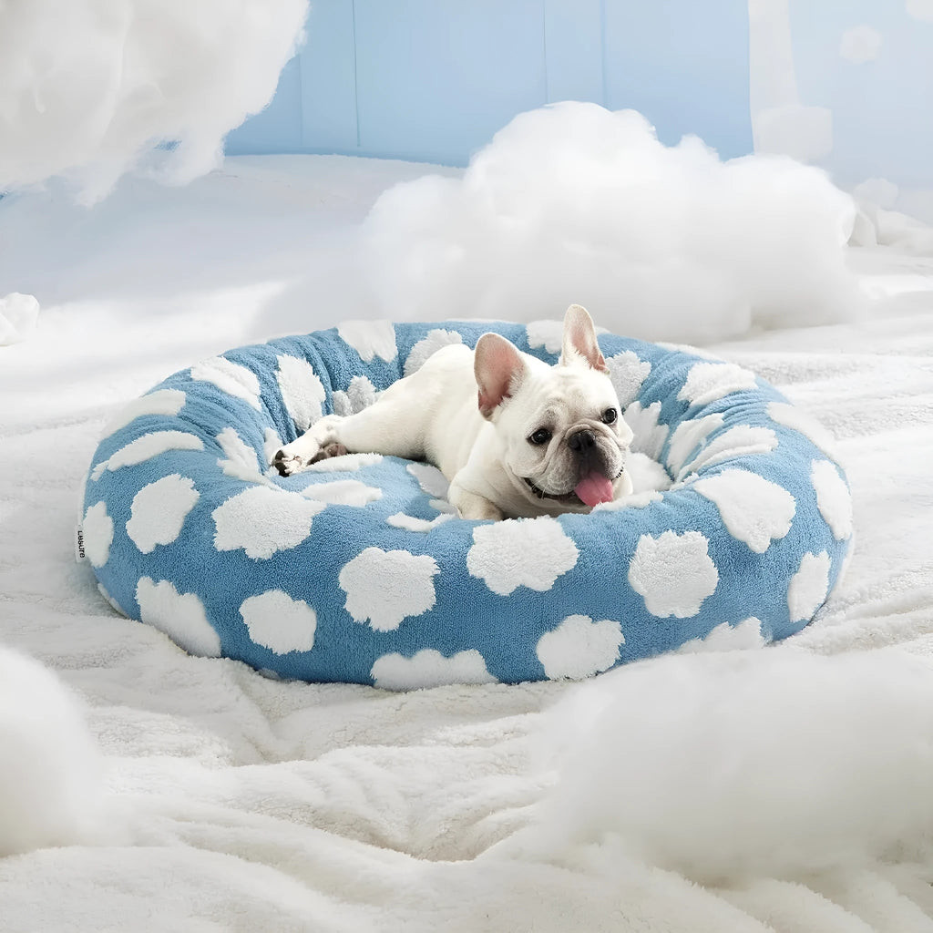 Round plastic dog bed with plaid fabric cover in blue and white pattern