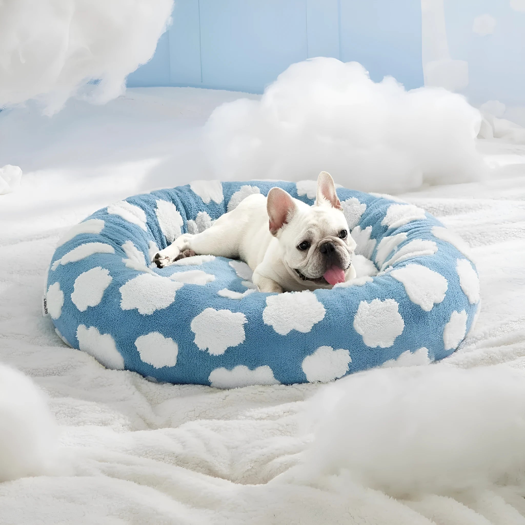 Round plastic dog bed with plaid fabric cover in blue and white pattern