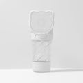 Green 3-in-1 portable pet water bottle with food container and waste bag dispenser on a strap.