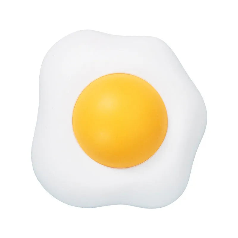 Soft plush catnip ball toy in egg shapes stuck to a wall for interactive cat play.
