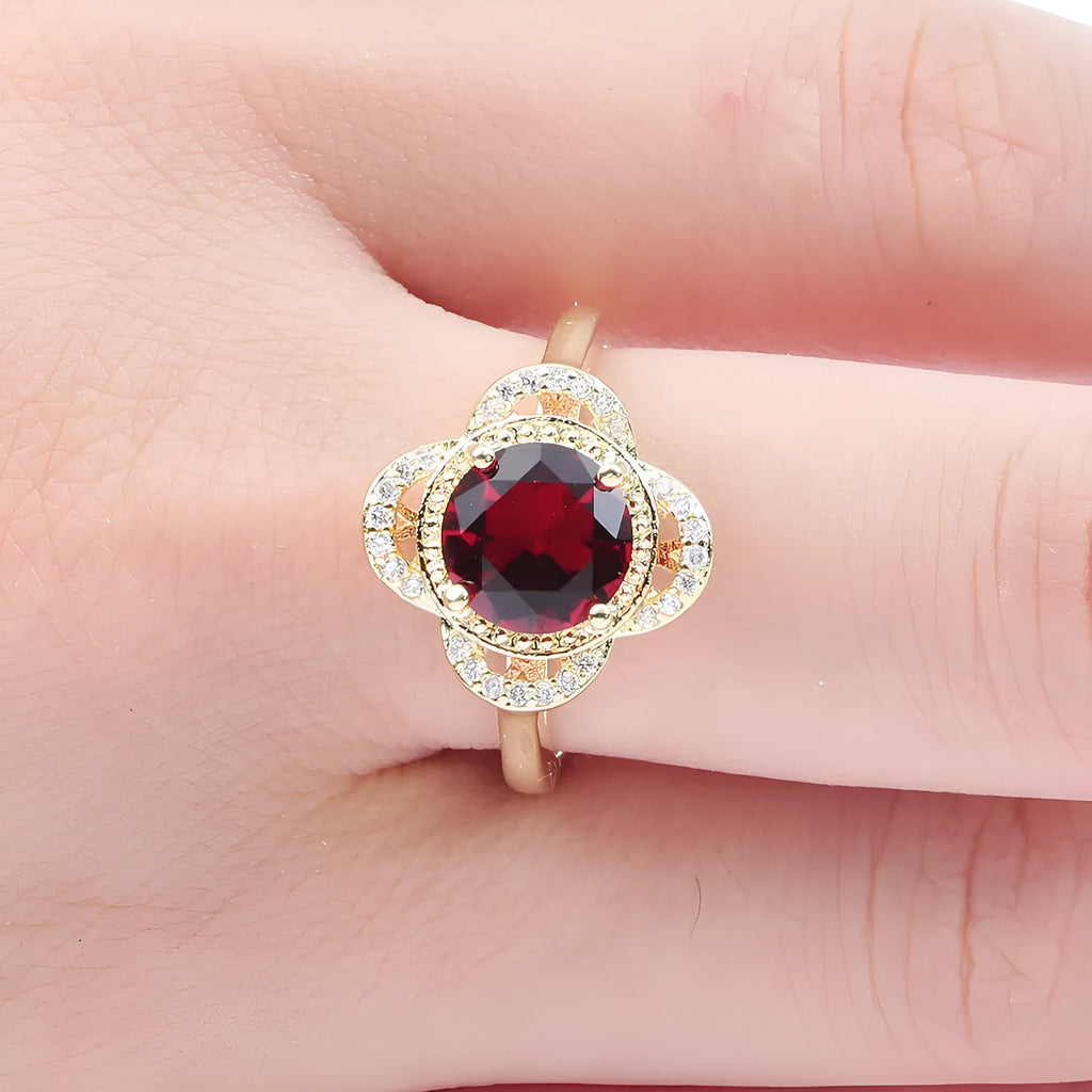 Copper ring with a zircon stone inlay in a fruit shape design on a finger.