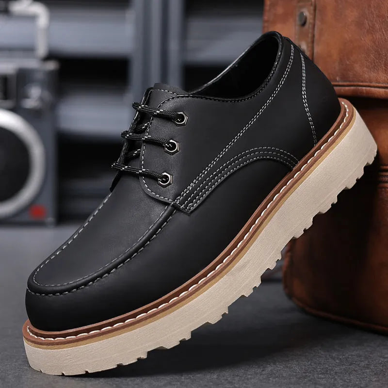Men's black retro Martin boots with round toe and rubber sole showing height-increasing mid heel