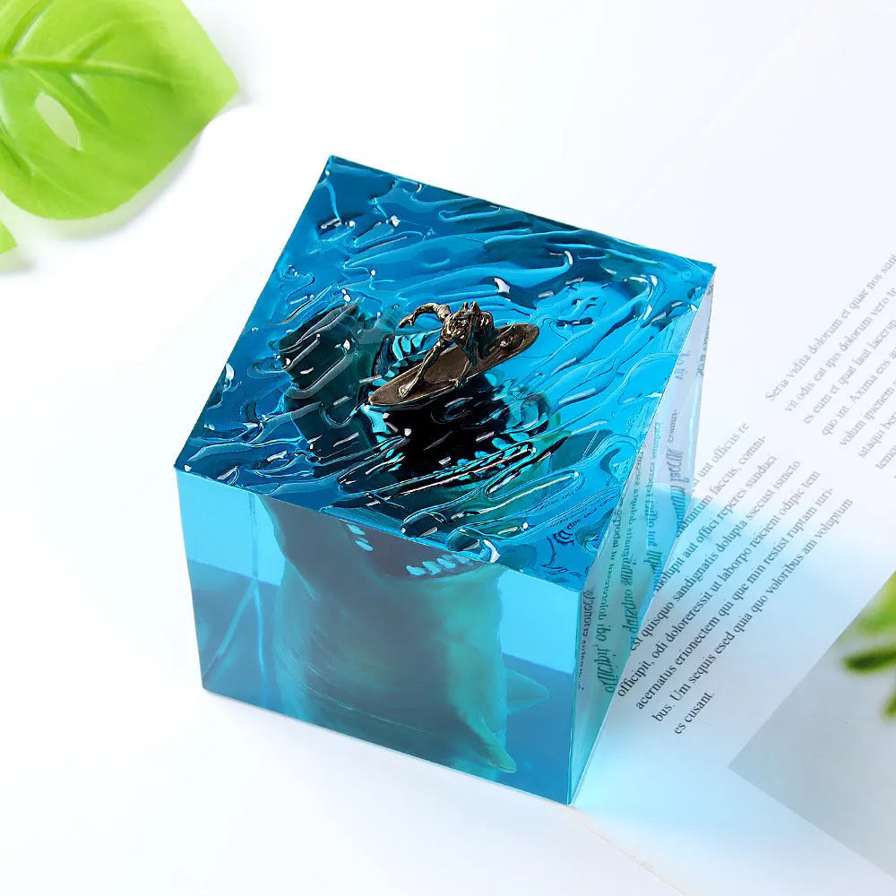 Epoxy resin shark surfer night light ornament on a desk with glowing micro landscape.