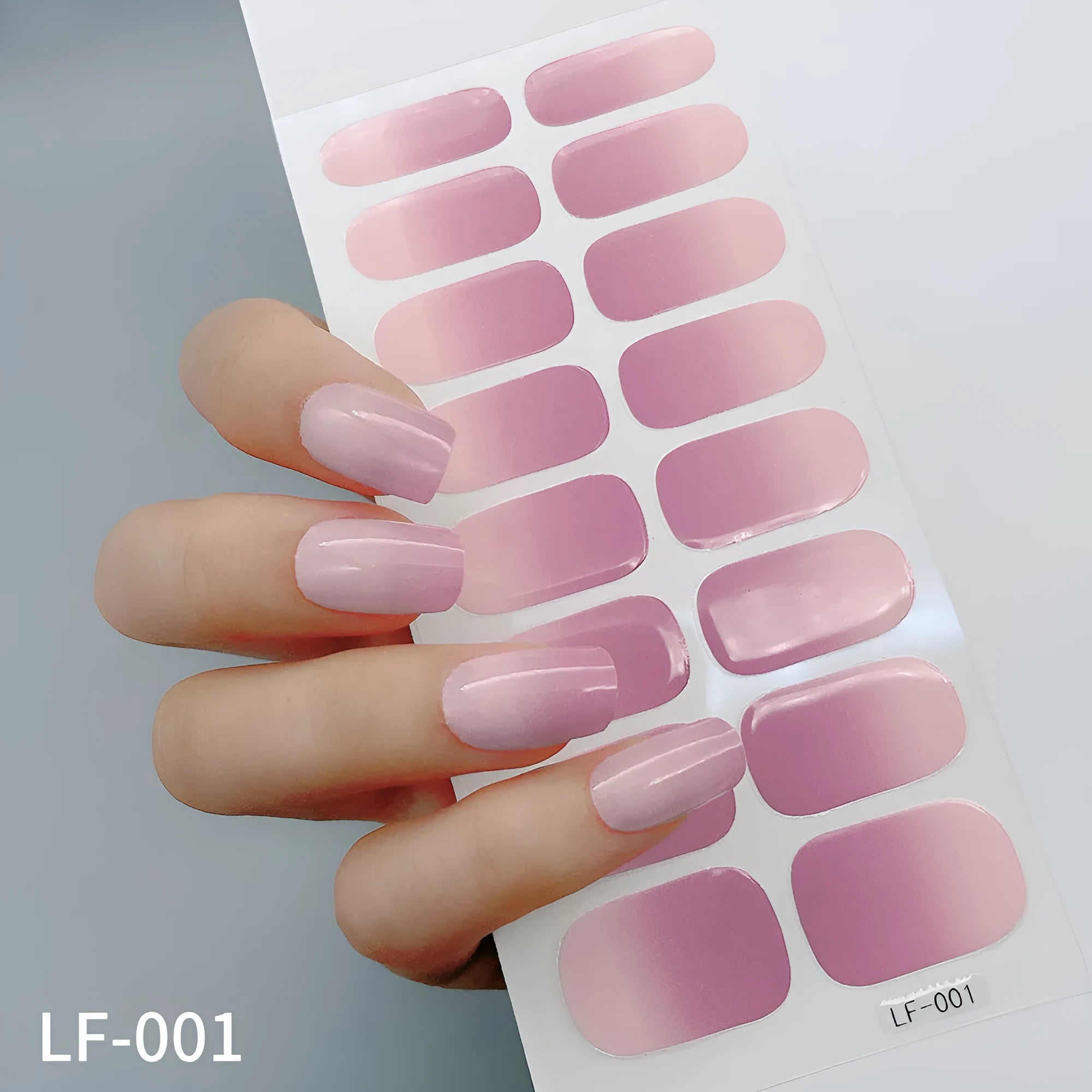 Full sheet of nail art stickers showing sixteen small designs including cross, rose, tulip, and leopard print patterns.