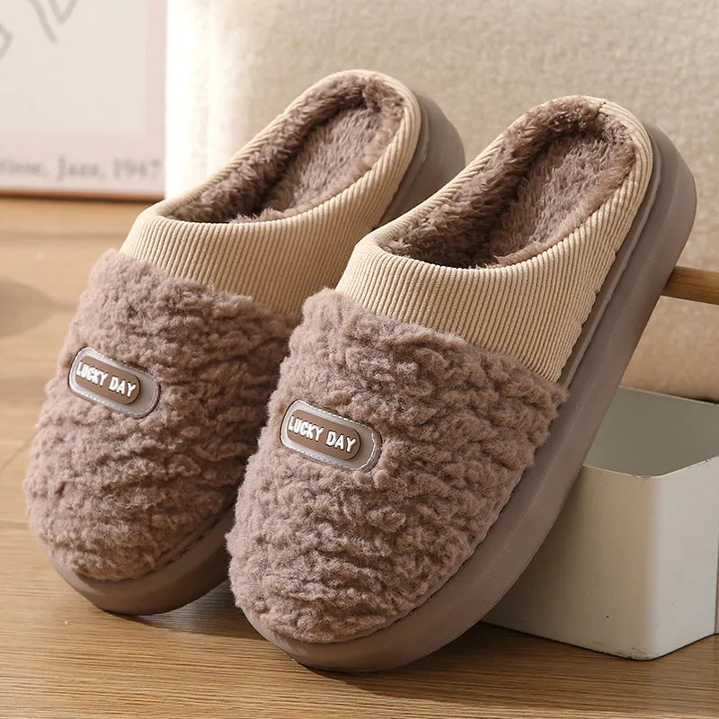 Men's grey thick-soled winter slippers with rabbit hair upper and textured sole.