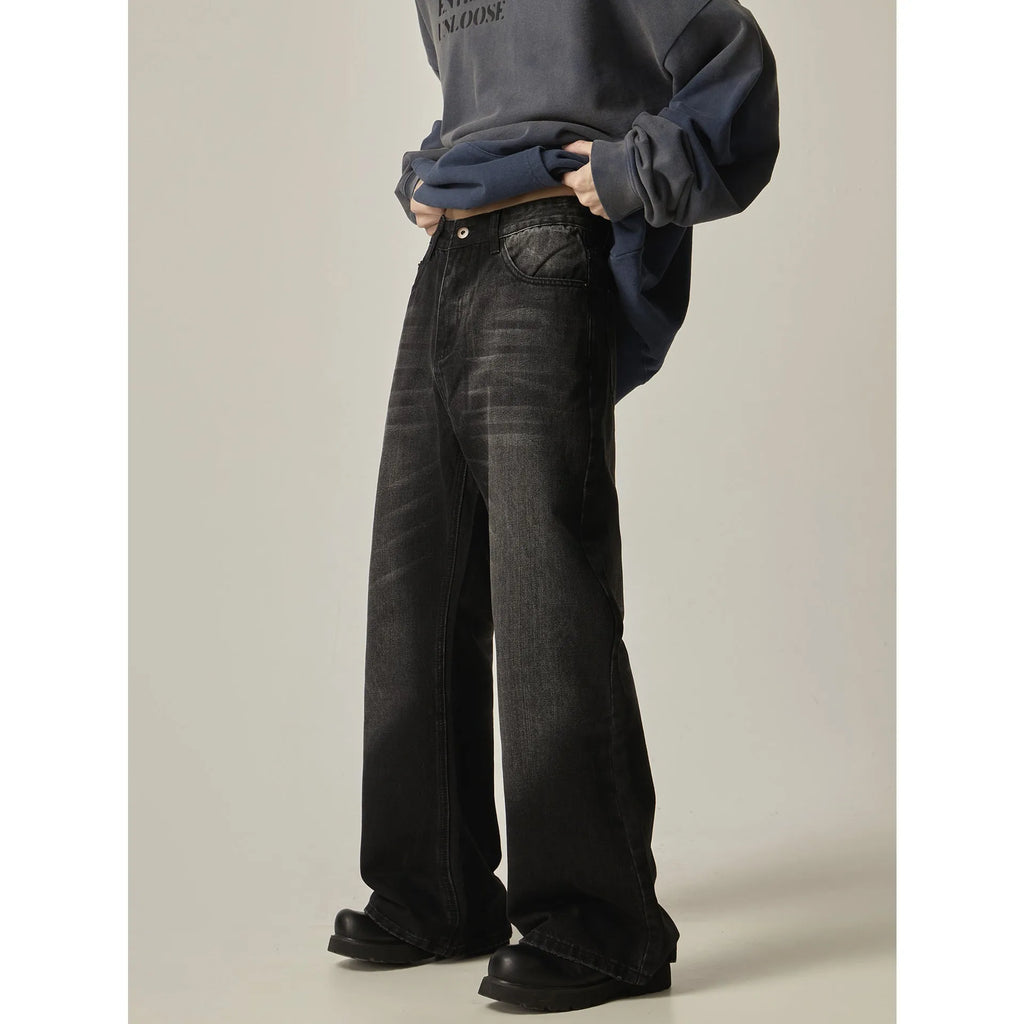 Black loose straight-leg retro jeans on a mannequin, showing zipper fly and relaxed fit.