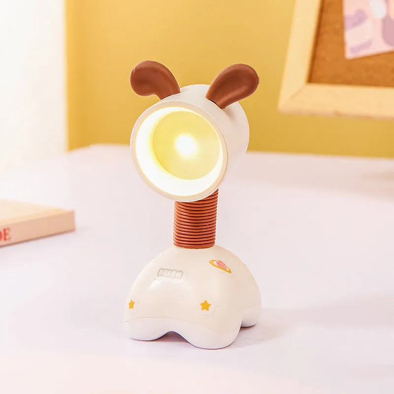 DIY cartoon animal small night lamp with magnetic base in assorted colours on a desk.