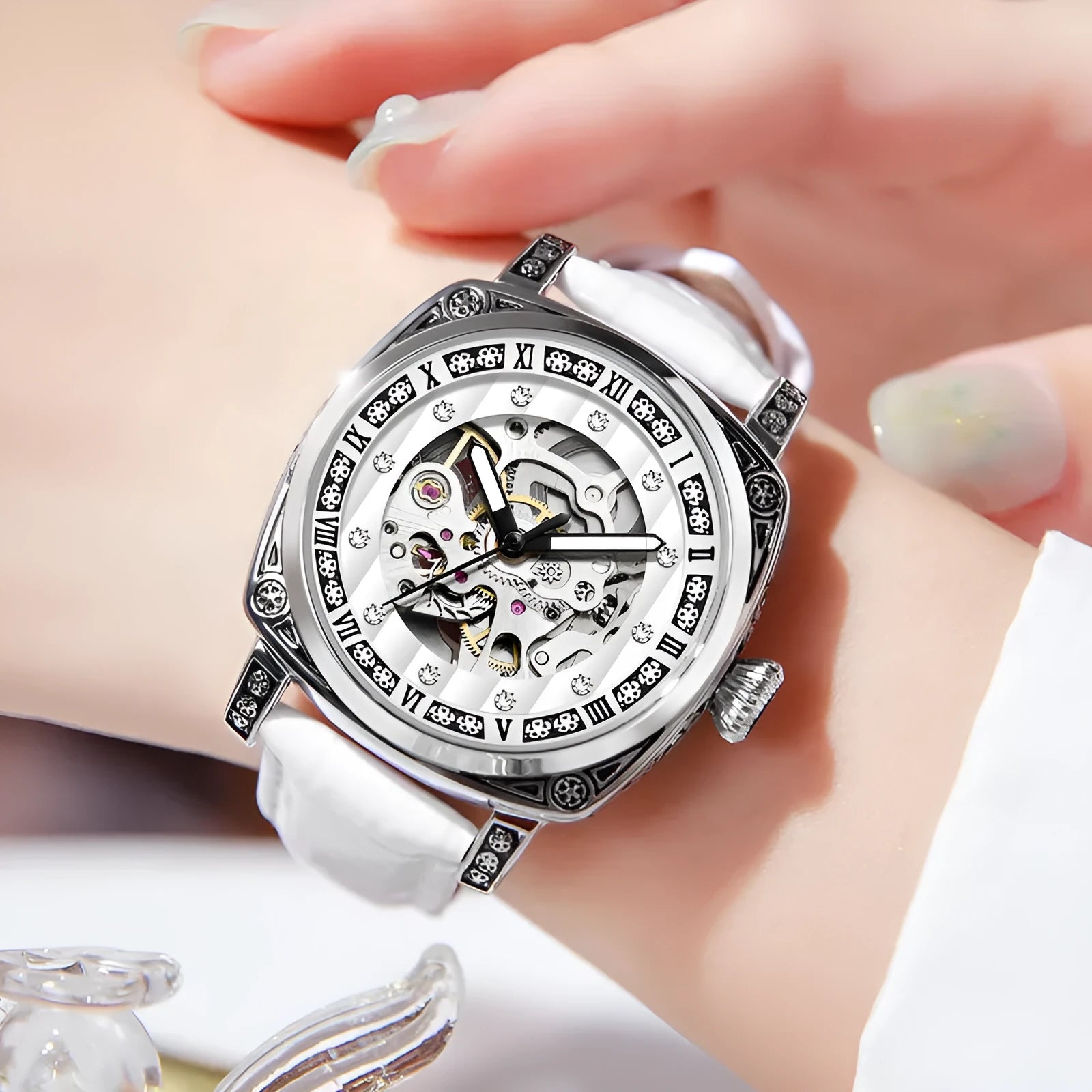 Mechanical wristwatch with luminous hands on a leather strap, shown in multiple colour options.