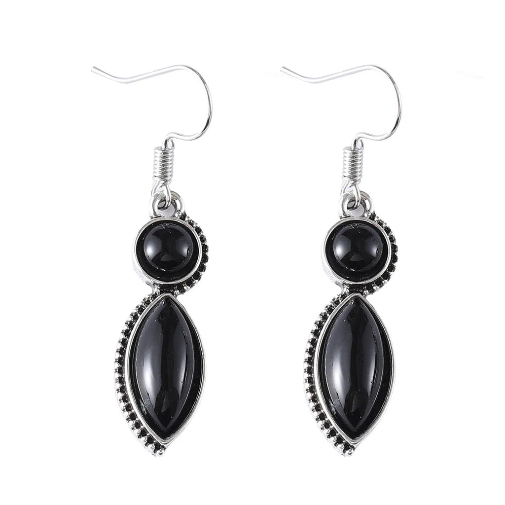 A pair of geometric vintage pendant earrings in black and purple colours with a bohemian style.